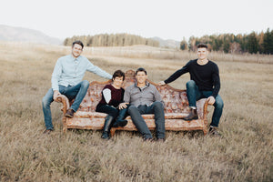 Dayton Ricketts in a family photo on a vintage couch at Standard Ridge wedding venue
